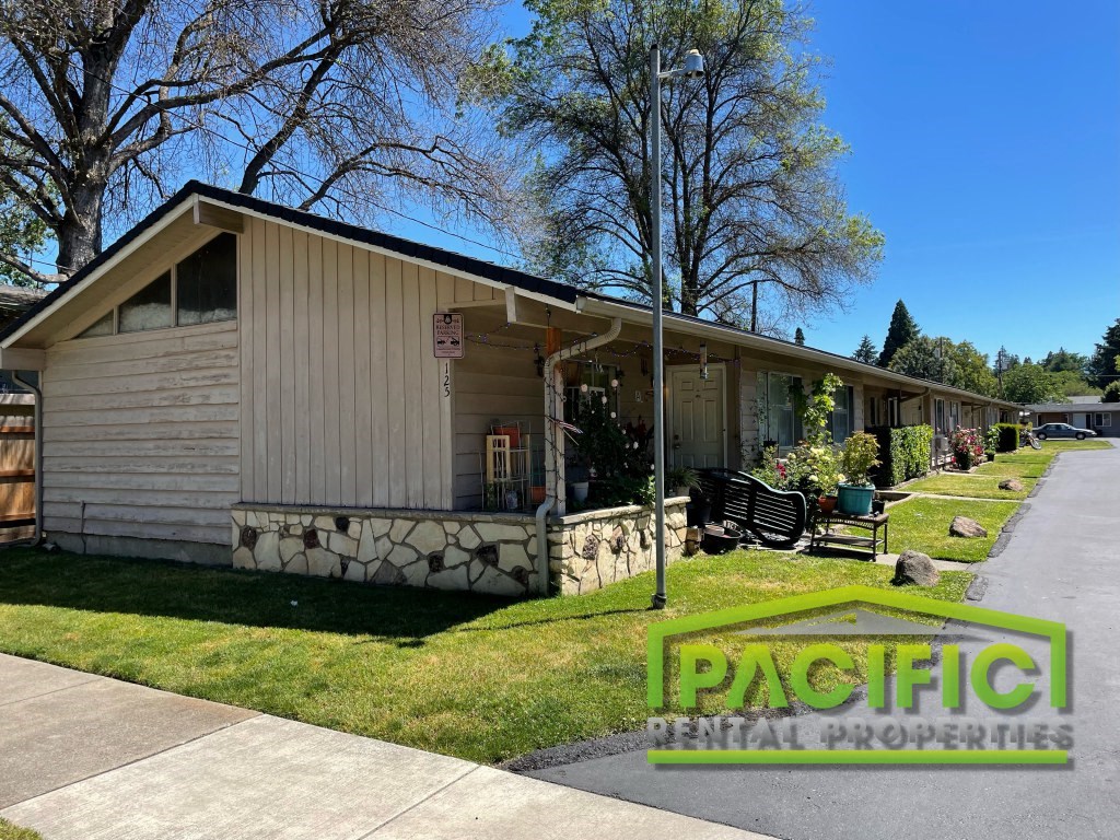 a small tan and on the side of a street