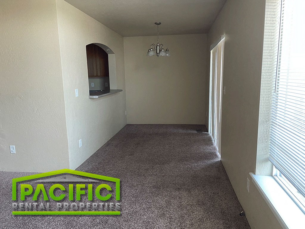 a carpeted hallway in a home with a carpet logo on the floor