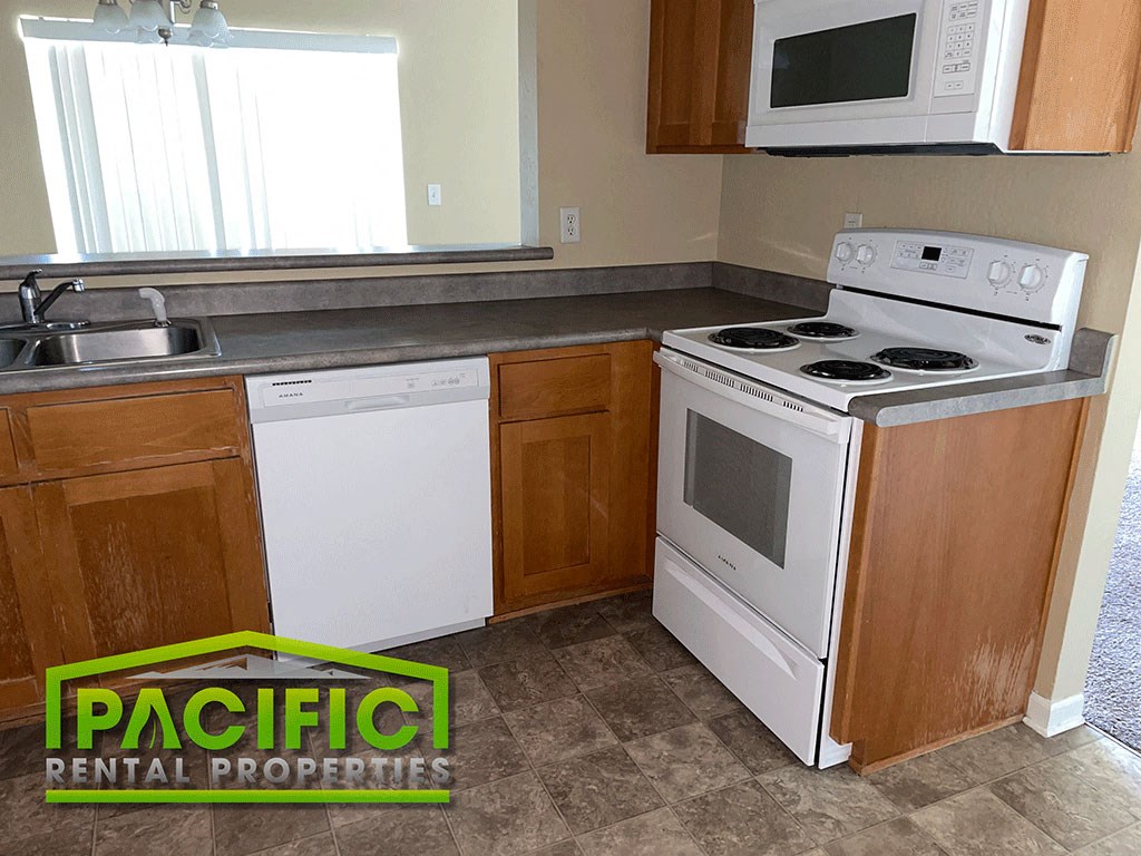a kitchen with a stove microwave and dishwasher and a sink