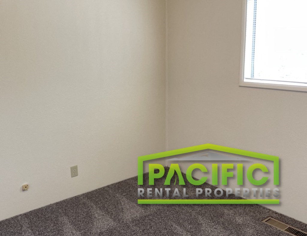 an empty room with a sign for pacific rental properties
