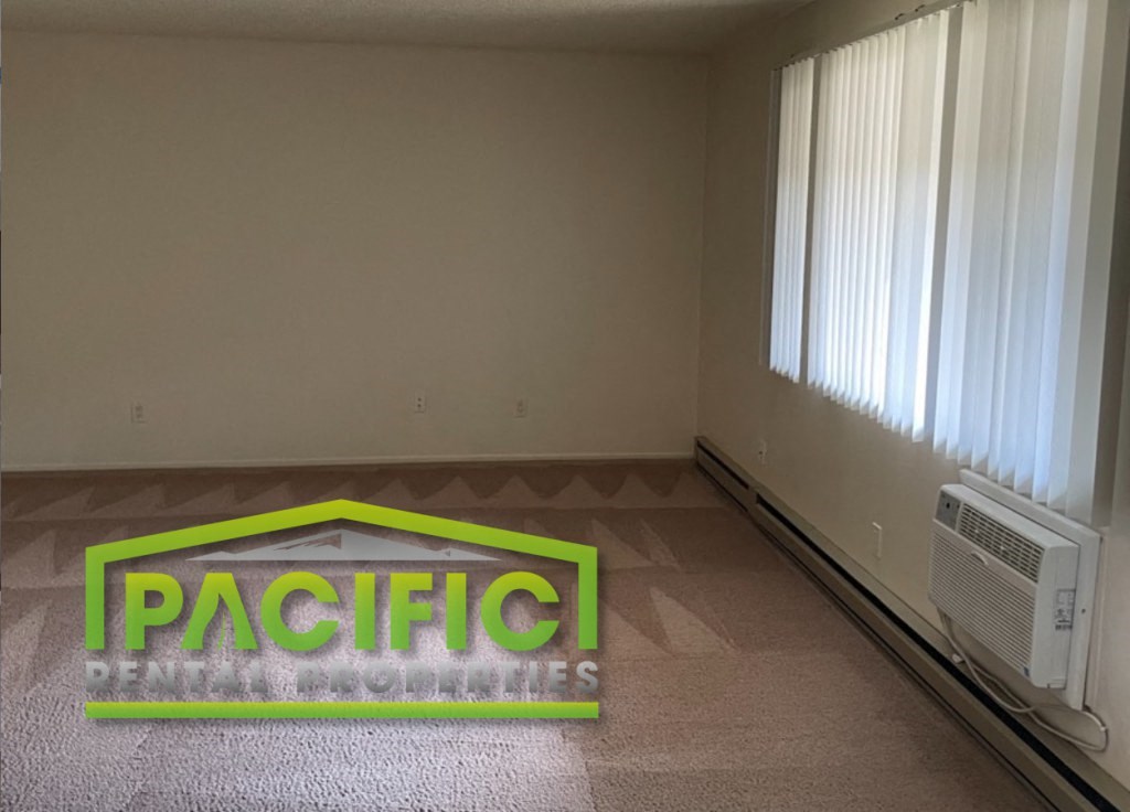 an empty room with a pacific dental offices logo on the floor