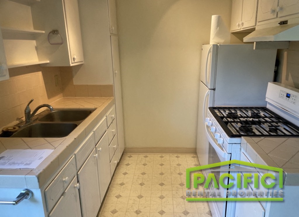 a small kitchen with a stove and a sink