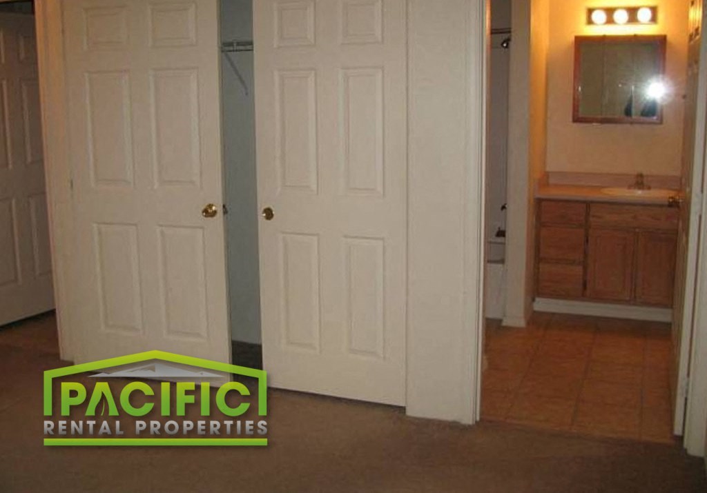 a bathroom with a closet and a white door