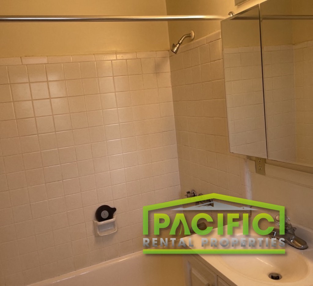 a bathroom with a green sign on the sink