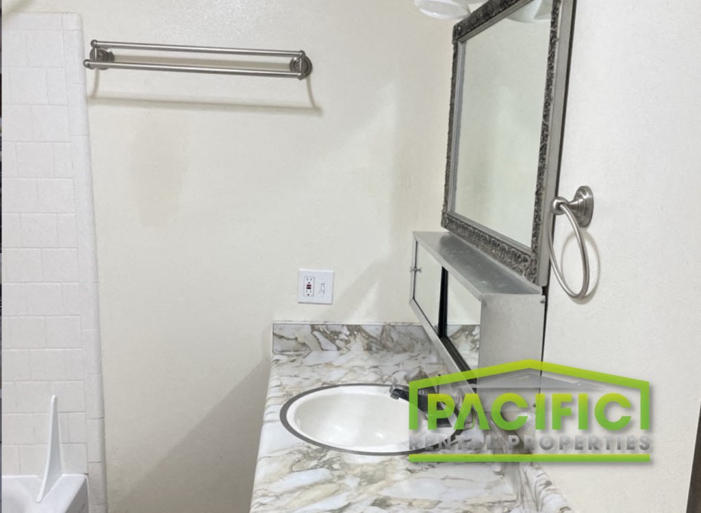 a small bathroom with a sink and a mirror