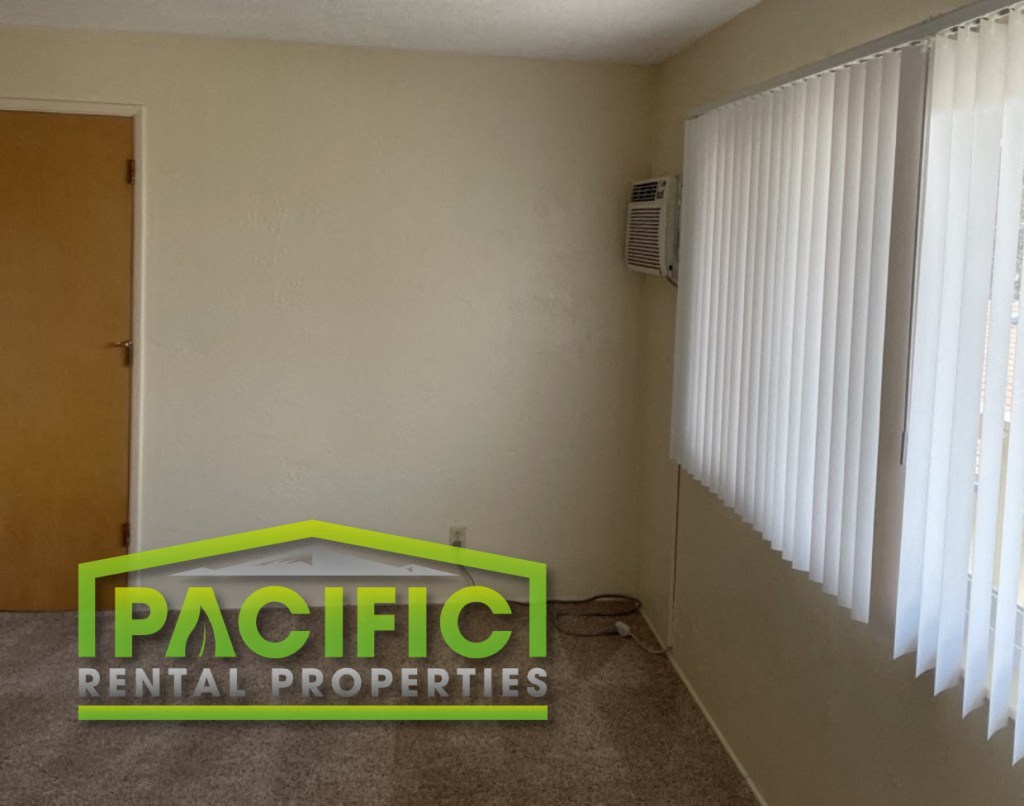 an empty room with a sign that says pacific rental properties