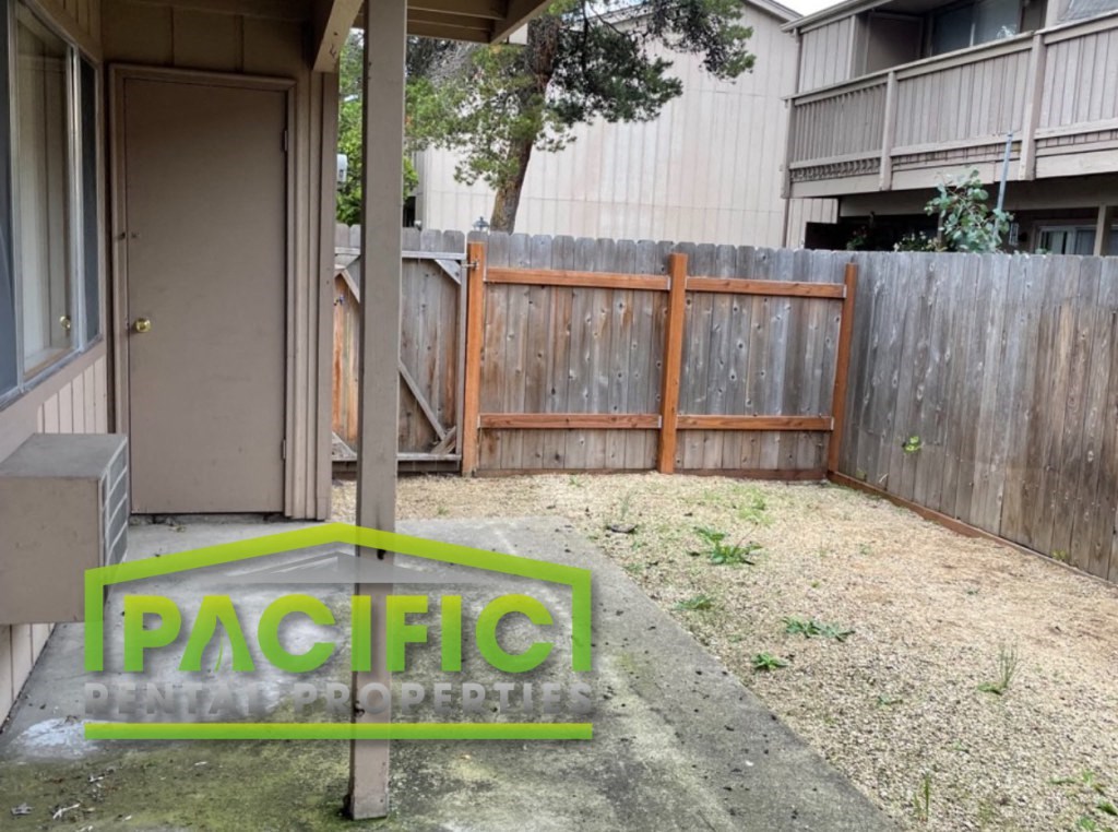 a fenced in backyard with a fence and a gate