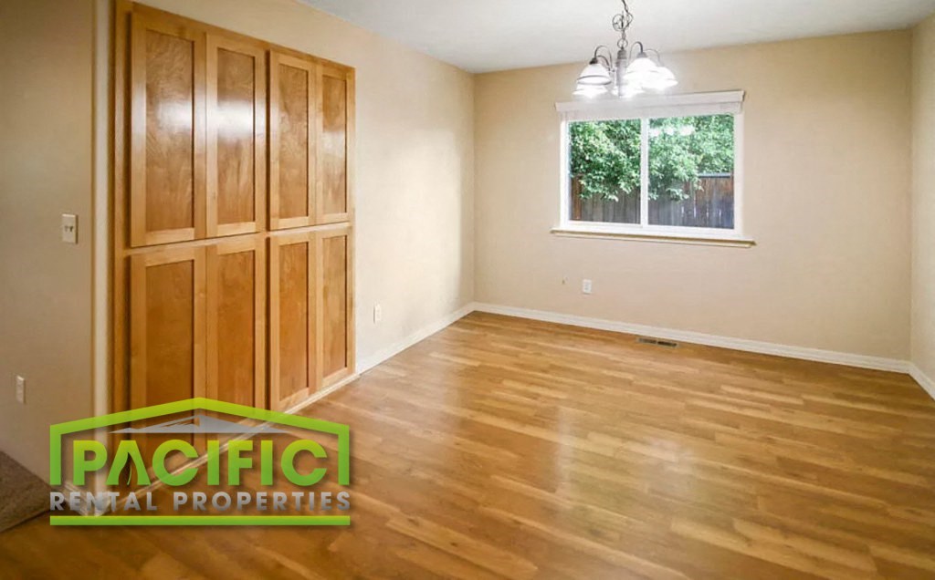 the living room of an empty house with wooden floors