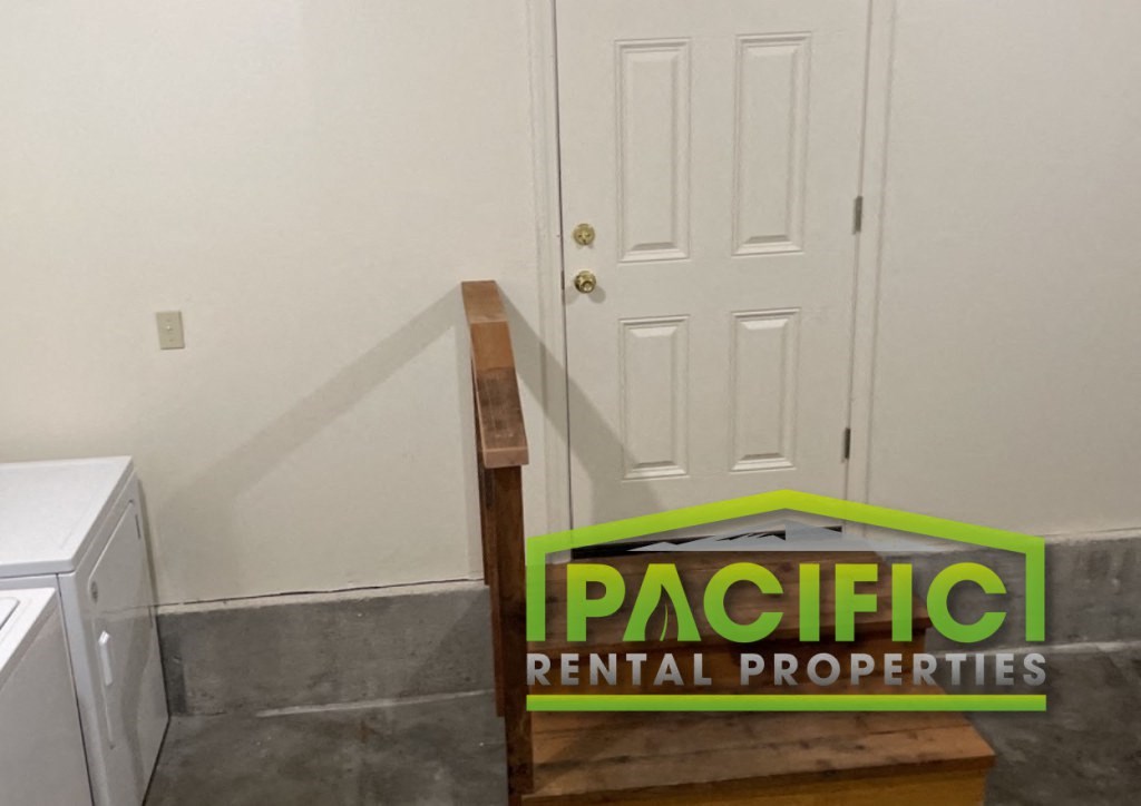 a door in a room with a sign for pacific rental properties