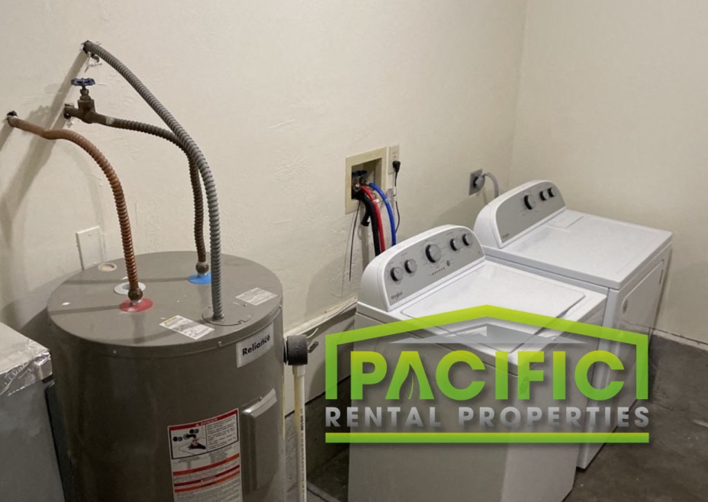 a small room with a refrigerator and a water heater