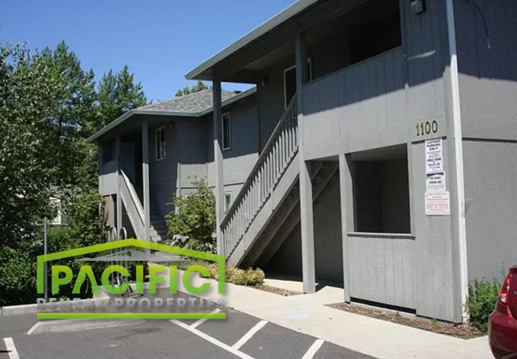 a building with stairs and a parking lot