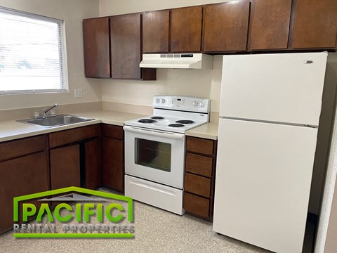 a kitchen with a stove refrigerator and a sink