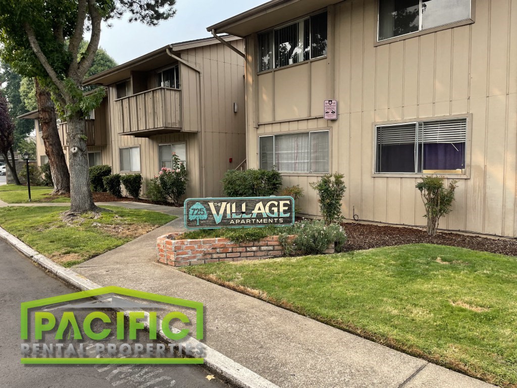 a street sign in front of an apartment building