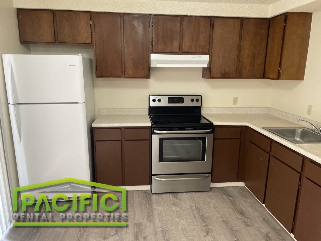 a small kitchen with a stove and a refrigerator