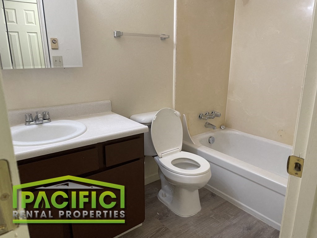 an image of a bathroom with a toilet sink and tub