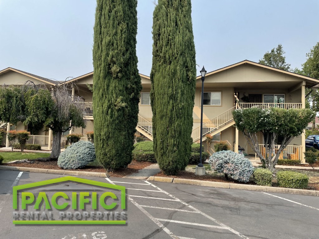an empty parking lot in front of an apartment building
