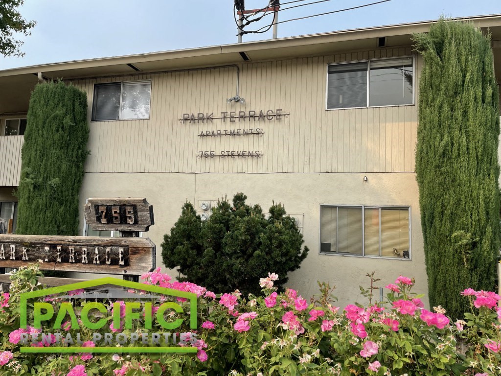 the front of the pacific terrace nursing home with pink flowers