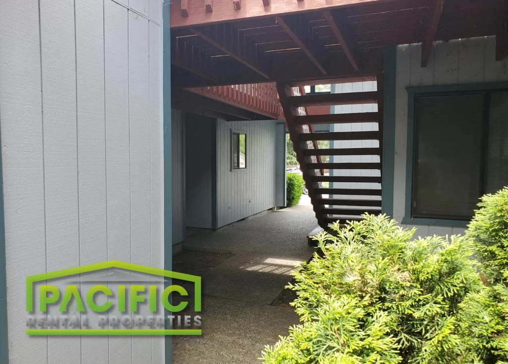 a house with a covered walkway and a staircase