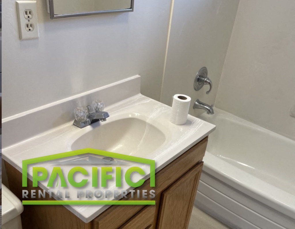 a bathroom with a sink and a roll of toilet paper on it