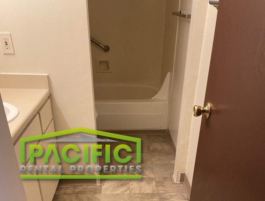 a bathroom with a toilet and a bath tub