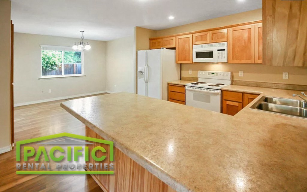 a kitchen with wooden cabinets and a large counter top