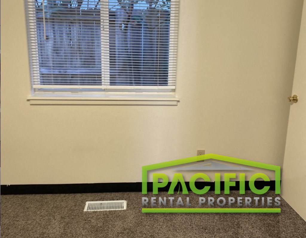 a room with a window and a plastic rental properties sign on the floor