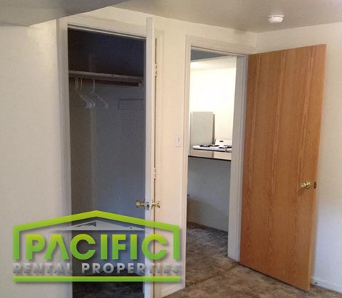 a small room with a closet and a door to a bathroom