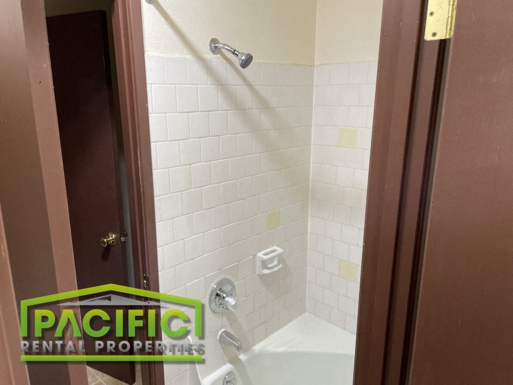 a small bathroom with a shower and a tub