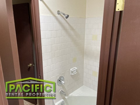 a small bathroom with a shower and a tub