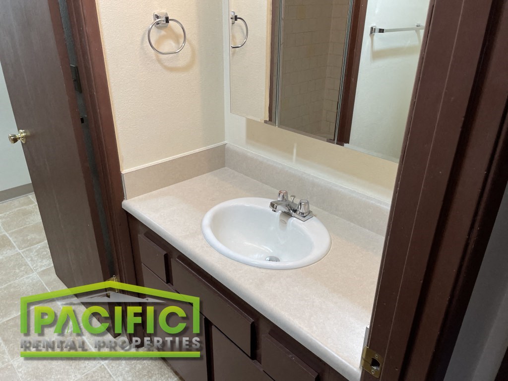 a small bathroom with a sink and a mirror