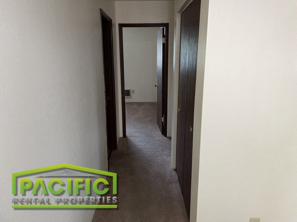 a room with a hallway and a door to a closet