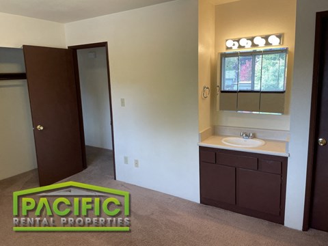 an empty bathroom with a sink and a mirror
