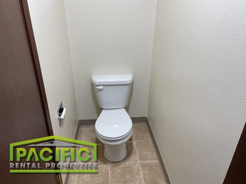 a small bathroom with a toilet and a door