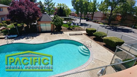 an aerial view of a swimming pool with a patta rental properties sign