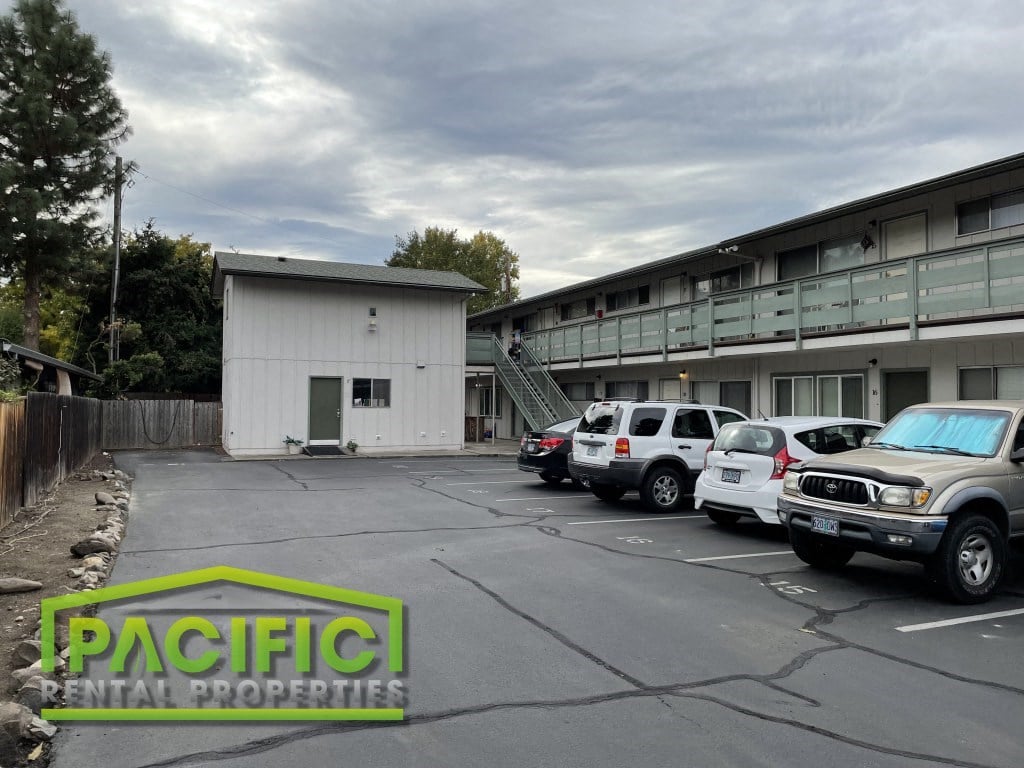 a parking lot with cars in front of a building