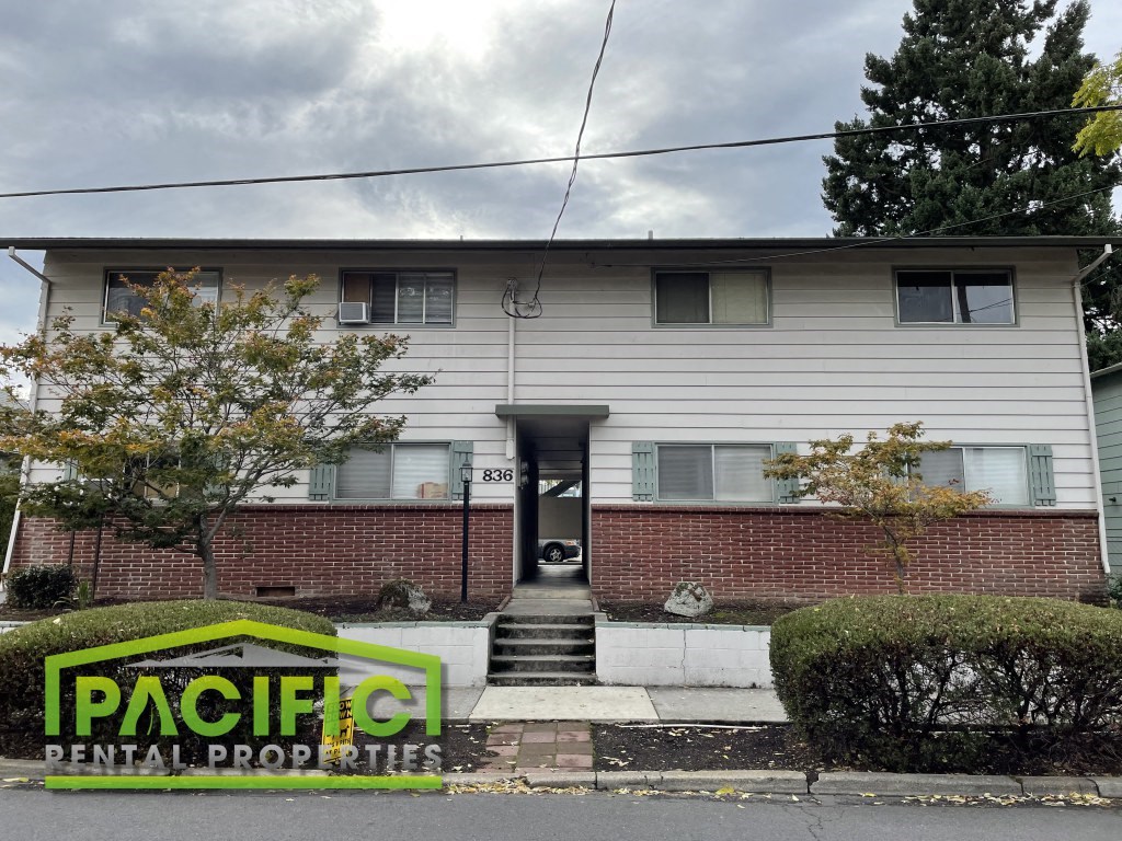 a white house with a red brick