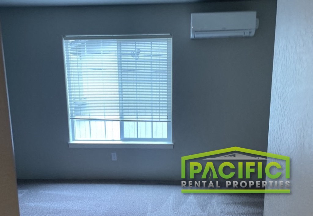 an empty room with a window and a pacific dental properties logo