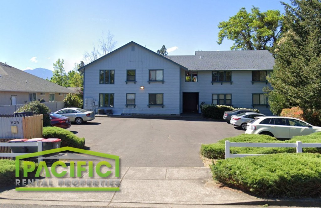 a large white building with cars parked in front of it
