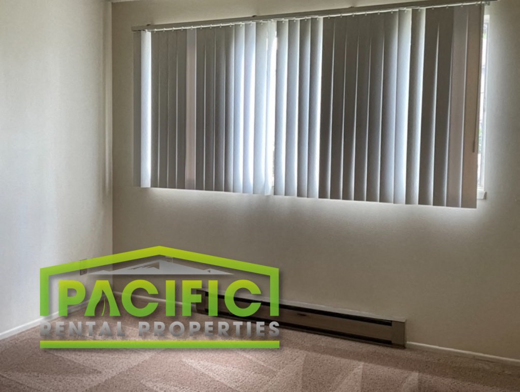 a logo for pacific dental properties on a wall under a window
