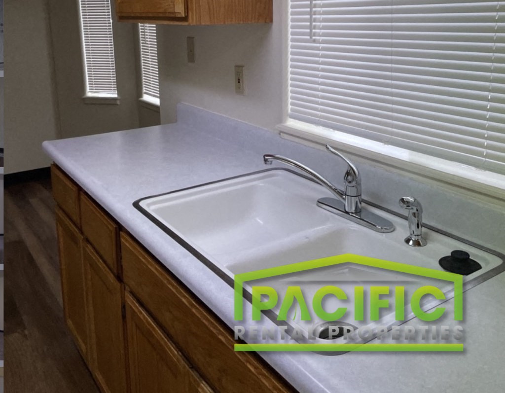 a white counter top with a sink in a kitchen
