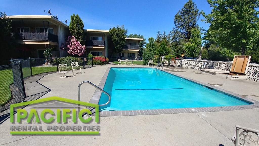 a swimming pool in front of an apartment building