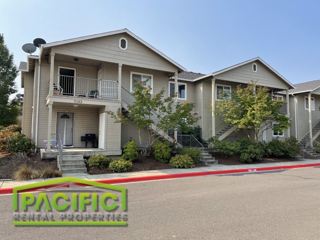 a home with a parking lot in front of it