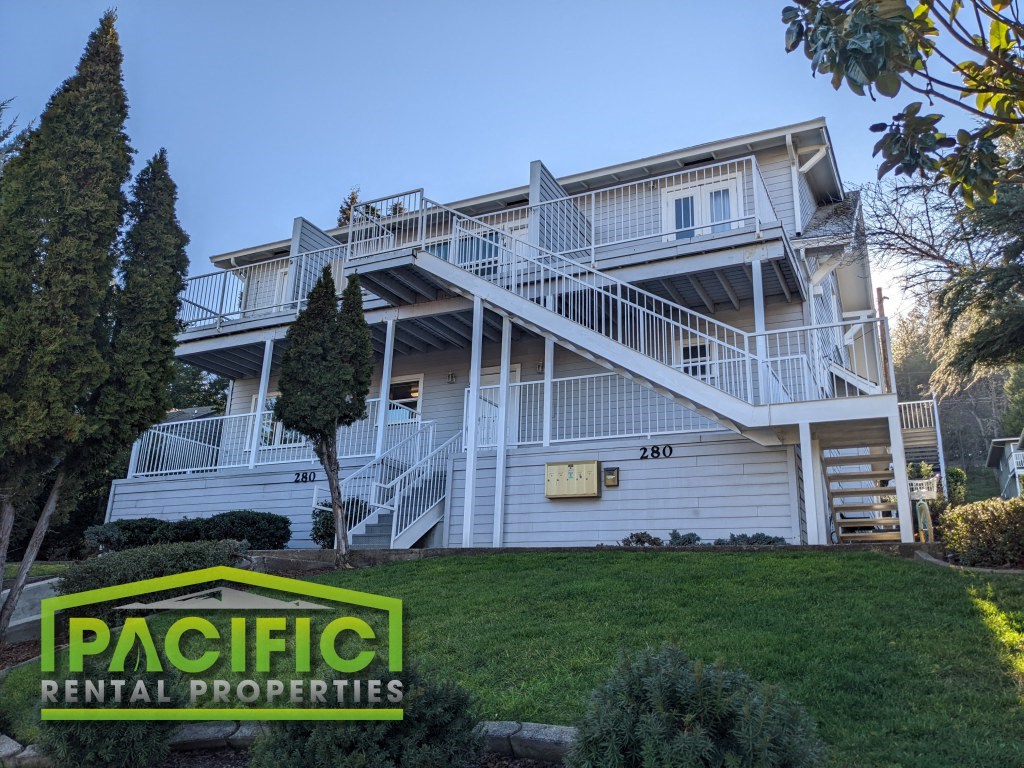 a large white house on a hill with stairs