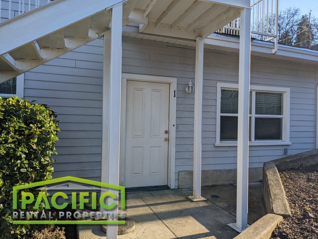 a small white house with a white door and a porch