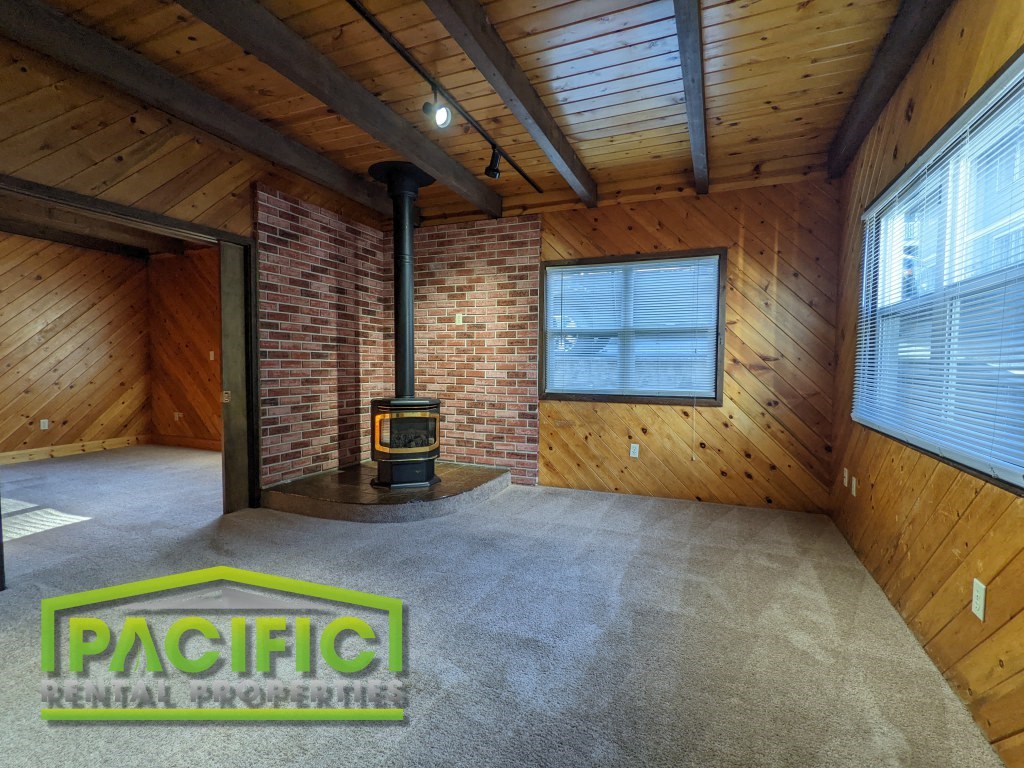 the living room of a house with a wood burning stove