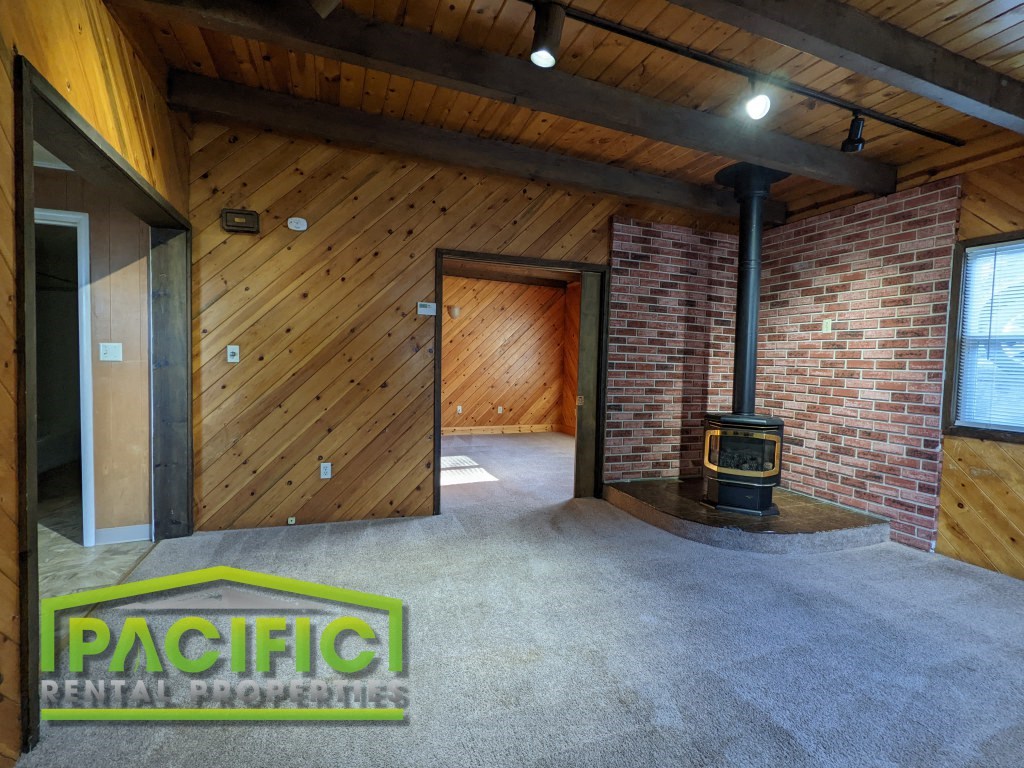 the living room of a house with a wood burning stove