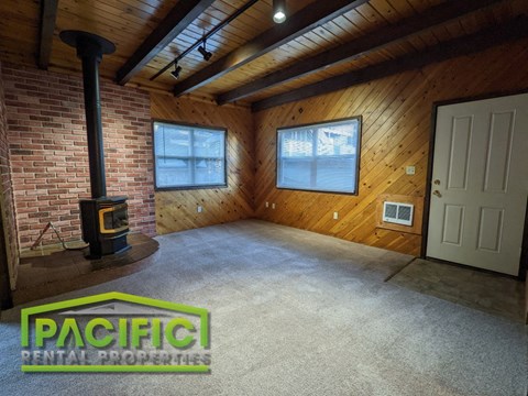 the living room of a home with a wood burning stove