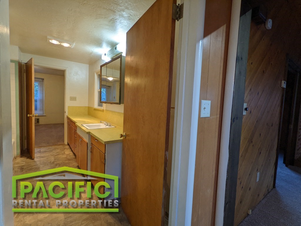 a bathroom with a sink and a mirror in a house