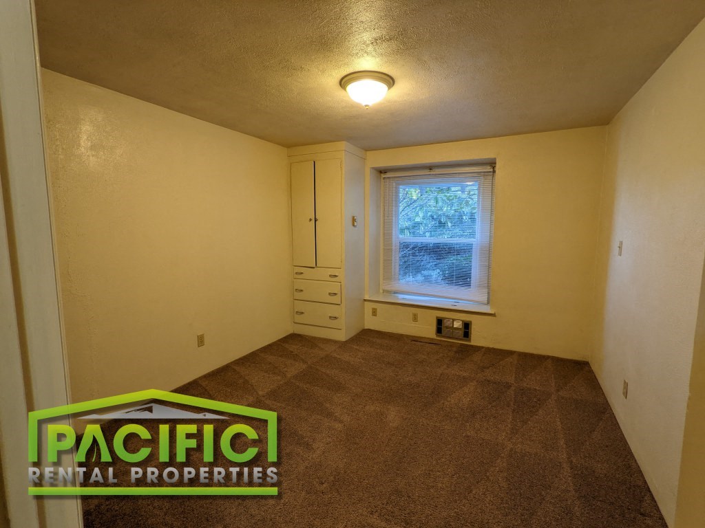 the living room of an empty house with a window