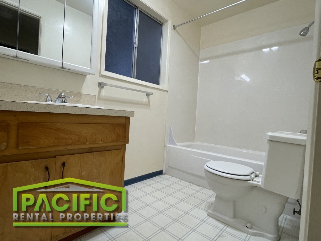 a bathroom with a toilet and a sink and a bath tub